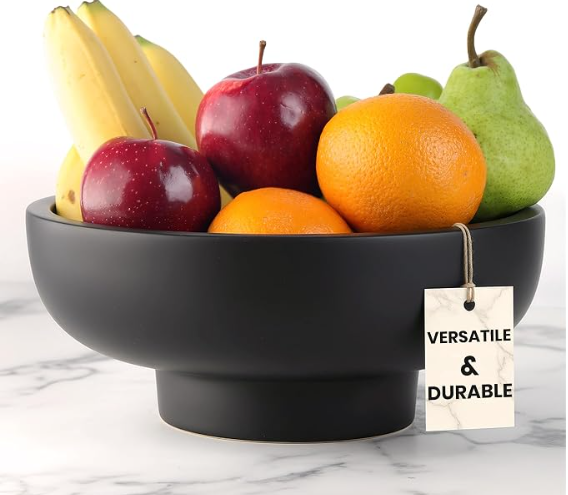 Lani Athletics handmade concrete decorative bowl in black, filled with fruit, on a marble counter